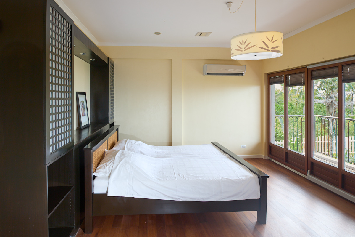Master bedroom with king-size bed and built-in headboard unit