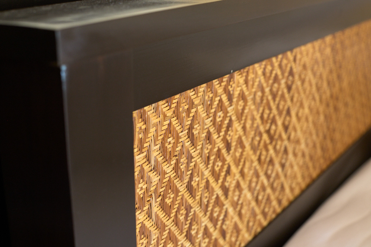 Hand-woven decoration on a solid-wood bed
